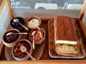 a tray with a loaf of bread and bowls of food at Hotel Escondido, Puerto Escondido, a Member of Design Hotels - Adults Only in Puerto Escondido