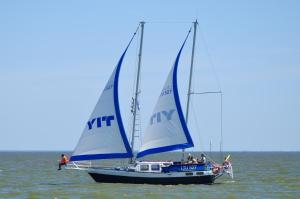two boats with blue sails in the water at Studio Relax in Nida