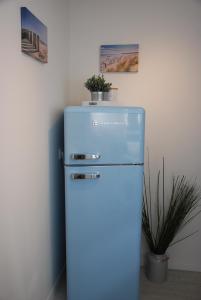 a blue refrigerator with a plant on top of it at Meine ECKE 2 in Eckernförde