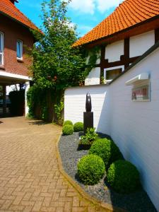 a courtyard of a house with a vase next to a building at Hotel Am Braunen Hirsch in Celle