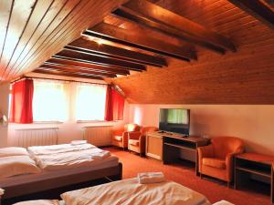 A bed or beds in a room at Penzion Montana