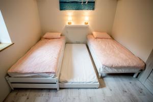 Voodi või voodid majutusasutuse Apartament Mrągowo toas