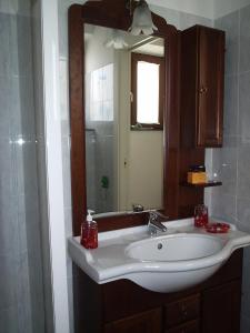 a bathroom with a white sink and a mirror at Elicrim in Santo Stefano di Magra