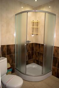 a shower in a bathroom with a toilet at Hotel Romantic in Byala