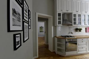 a kitchen with white cabinets and a counter top at Like at Home in Sopot