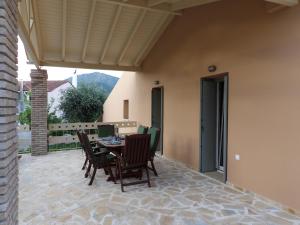a patio with a table and chairs on a patio at Apothiki House in Kato Korakiana