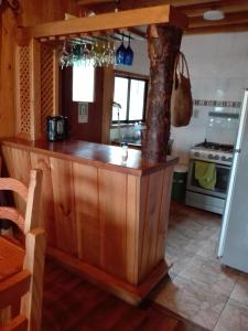 a kitchen with a wooden counter top in a room at Hostal Monica in Pucón