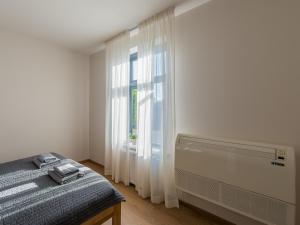 a bedroom with a bed and a window at Liepaja Apartments Downtown in Liepāja