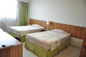 two beds in a hotel room at Boa Vista Eco Hotel in Boa Vista