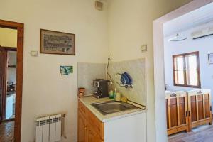 a kitchen with a sink and a counter top at Hostel Pashov in Veliko Tŭrnovo