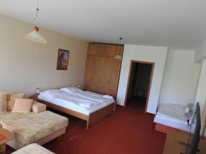 A bed or beds in a room at Penzion Montana