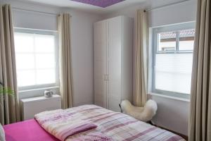 a bedroom with a bed and a window at Feriendomizil "Alte Post" I in Pronsfeld