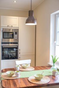 a kitchen with a wooden table with bowls on it at Feriendomizil "Alte Post" I in Pronsfeld