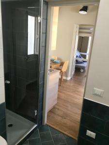 a shower with a glass door in a bathroom at Le casette di Elen in Marsala