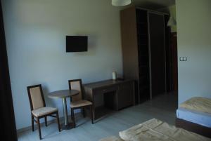 a bedroom with a desk and two chairs and a table at Villa Camp in Jurata