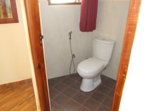 a bathroom with a white toilet in a room at Central City Hostel in Kandy