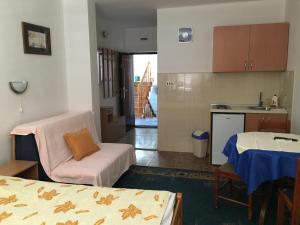 a room with a kitchen and a living room at Apartments Upitnik in Herceg-Novi