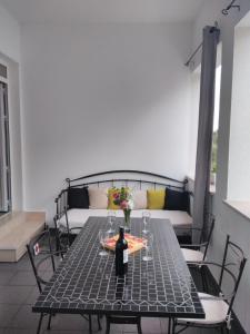 a table with a bottle of wine on top of it at Apartment Tomo in Ražanj