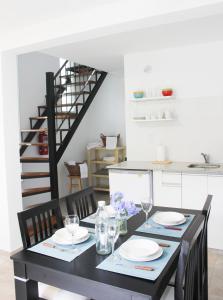 a black dining room table with plates and glasses at El Remanso Chascomus in Chascomús +19 photos