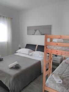 a bedroom with two beds and a bunk bed at Apartment Tomo in Ražanj