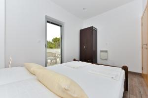 Postel nebo postele na pokoji v ubytování Apartmani Iva