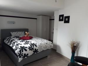 a bedroom with a bed with a teddy bear on it at Bella Casa & Belle Maison in Saarbrücken