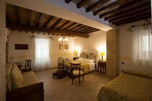 a bedroom with two beds and a table and chairs at Hotel Palazzo Brunamonti in Bevagna +56 photos