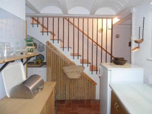 a kitchen with a spiral staircase in a house at Cal Son in Alpens