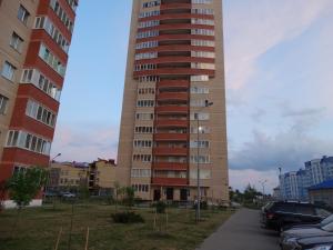 a tall building with cars parked in front of it at Apartment-studio Katerina in Brest