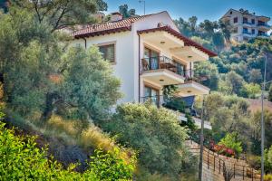 a house on a hill with trees at Kasinn Apart Turuncu in Kaş