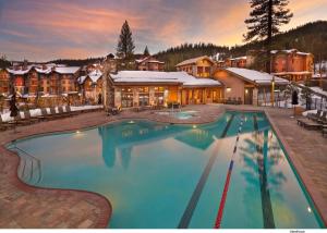 a large swimming pool in front of a resort at The Residences at One Village Place by Hyatt Vacation Club in Truckee