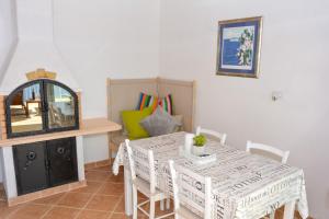 a dining room with a white table and chairs at Apartment and room Sveti Jakov in Dubrovnik