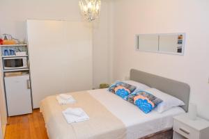 a bedroom with a bed with two pillows on it at Apartment and room Sveti Jakov in Dubrovnik