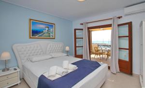 a bedroom with a bed and a view of the ocean at Anna Maria - Vanessa Apartments in Neo Klima