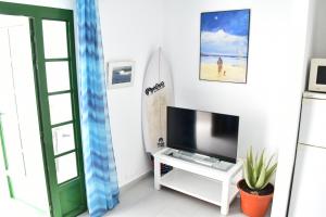 A television and/or entertainment centre at Puerto del Carmen center - New Apartment by the pool and private parking
