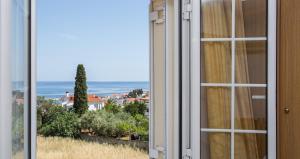 a window with a view of the ocean at Malvasia Corner Studios - ex Romeo's House in Monemvasia