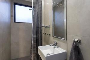 a bathroom with a sink and a shower at Breeze Lodge in Brisbane