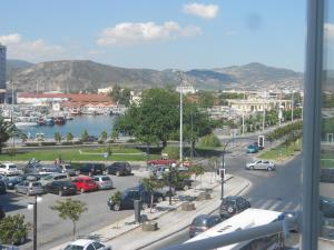 a city with a lot of cars parked in a parking lot at Hotel Admitos in Volos