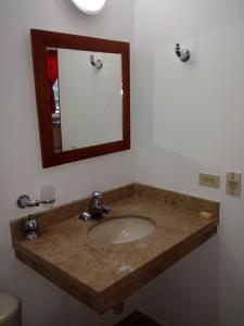 a bathroom with a sink and a mirror at Hotel Bahia Plaza in Santa Marta +56 photos