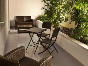 a patio with chairs and a table and a couch at TURIM Luxe Hotel in Lisbon