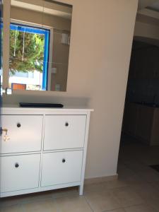a white dresser in a room with a mirror at Serifos Palace in Livadakia +37 photos