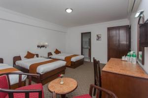 Voodi või voodid majutusasutuse Fuji Hotel toas