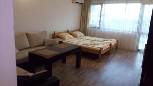 a living room with a couch and a table at Guest House Diamant in Sozopol
