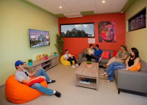 a group of people sitting in a waiting room at Breeze Lodge in Brisbane