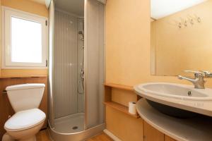 a bathroom with a toilet and a sink and a shower at Camping Klaus in Cavallino-Treporti +62 photos