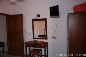 a room with a mirror and a table at Margaritis Apartments in Agia Anna Naxos