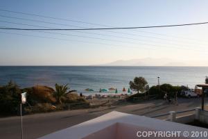 a view of a beach with umbrellas and the ocean at Margaritis Apartments in Agia Anna Naxos