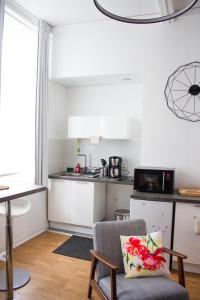 a kitchen with a table and a chair in a room at Appartements de Jeanne in Lille +24 photos