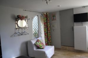 a living room with a chair and a window at Clos Mariotte in Vouvray
