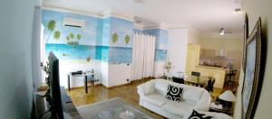 a living room with a white couch in a room at Villa Florencia in Boca Chica